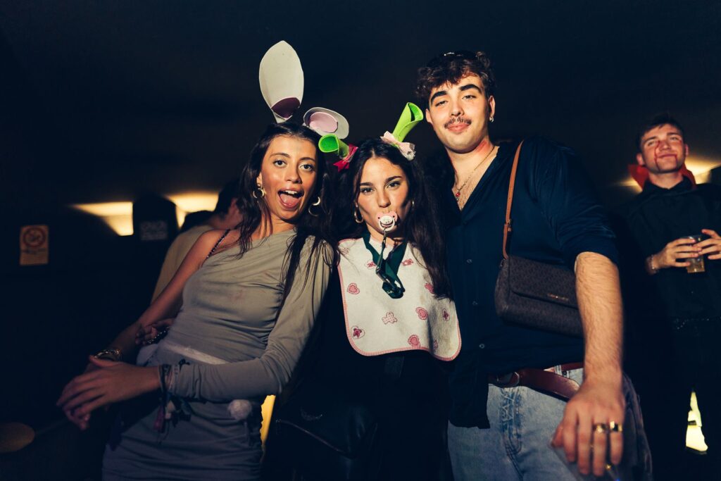 Friends in costume with pacifier and bunny ears at a Halloween party in Florence